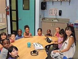 Kids and staff member at hear center Pasadena