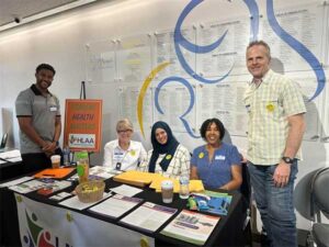 The Los Angeles chapter team sitting at their booth