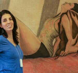 Priscila Soares in front of her painting work