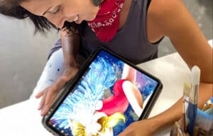 Priscila Soares working on her art on a tablet.